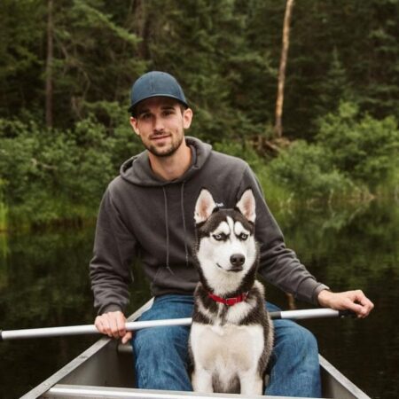 Man with dog in canoe on the lake