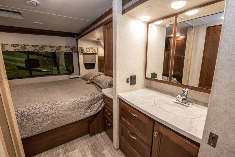 built in bathroom and bed in an rv