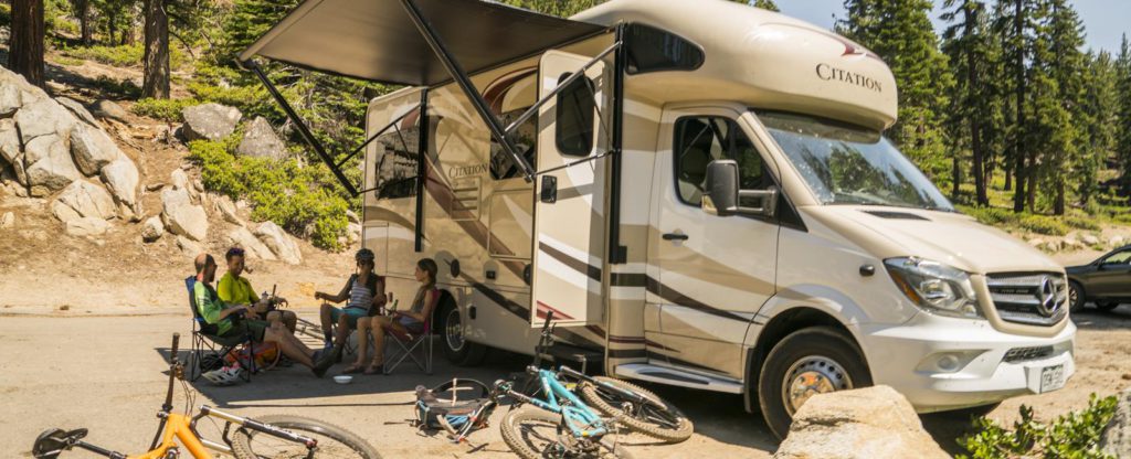 lounging in front of rvs with bikes