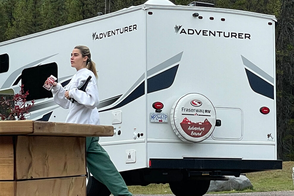 woman next to class c motorhome