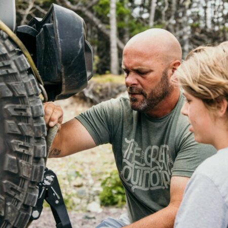 Bryan Baeumler and son hitching Jeep to RV