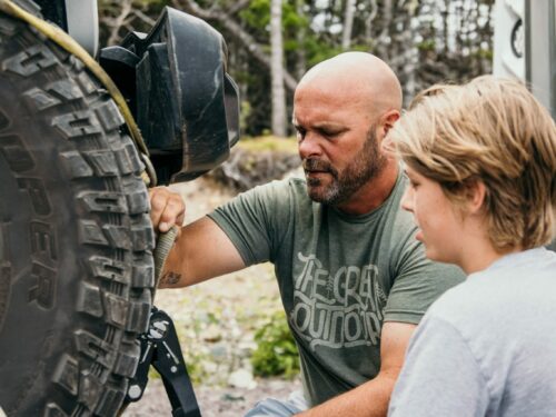 Bryan Baeumler with son hitching Jeep to RV