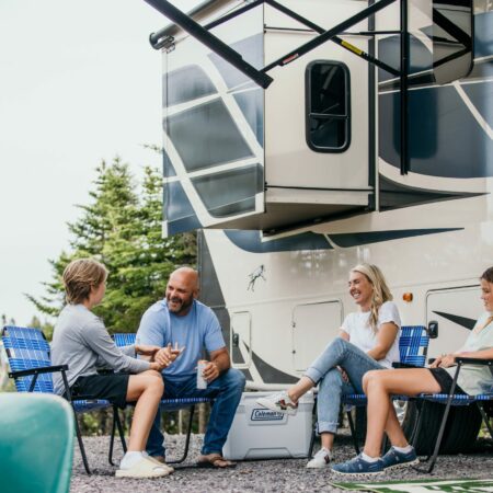 Bryan Baeumler and family sitting in front of their RV