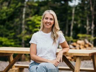 Sarah Baeumler posing for a photo at a campsite