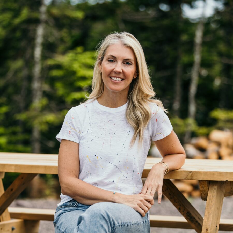 Sarah Baeumler posing for a photo at a campsite