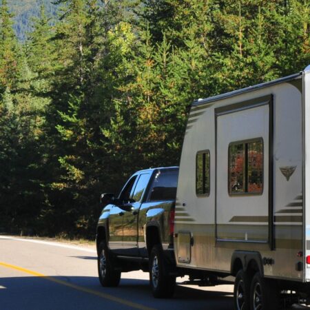 Truck towing a trailer along the road in Quebec