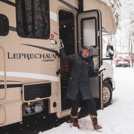 BGOW participant stepping out of the class C motorhome to fresh snowfall