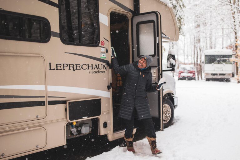 BGOW participant stepping out of the class C motorhome to fresh snowfall