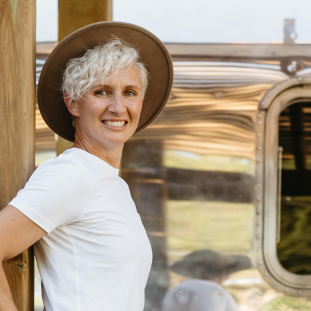 Chantal Larcher owner of Tiny Stays Airbnb standing in front of an Airstream RV