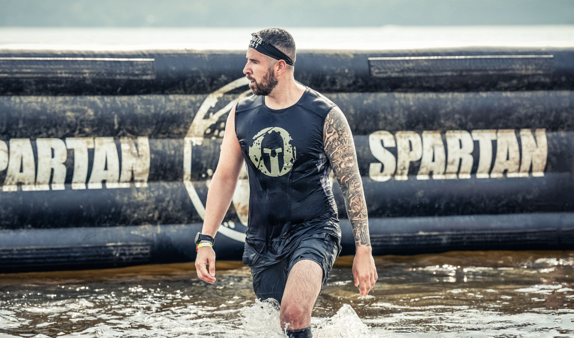 Alexandre Contreras walking through water of an obstacle at Spartan Race