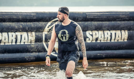 Alexandre Contreras walking through water of an obstacle at Spartan Race
