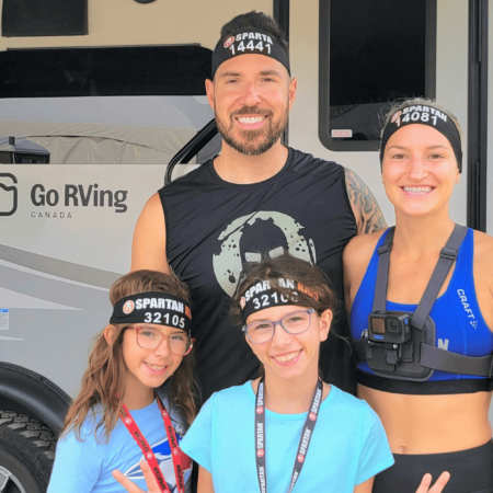 Spartan Race Ambassador Alexandre Contreras standing with his family in front of an RV