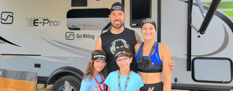Spartan Race Ambassador Alexandre Contreras standing with his family in front of an RV