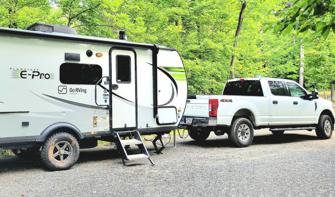 2021 Forest River FS.E-PRO 20BHS Travel trailer parked in a campsite hitched to a truck