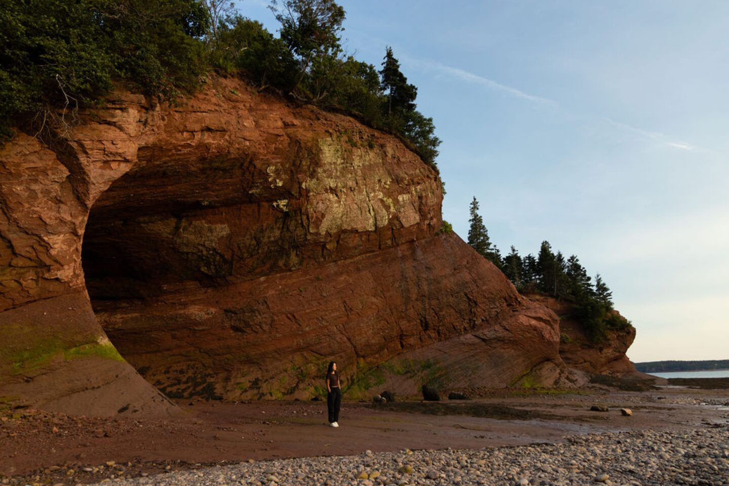 Woman standing at the edge of the St Martins Sea Caves