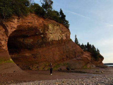Woman standing at the edge of the St Martins Sea Caves