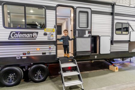 Child exiting a travel trailer RV at an RV Show