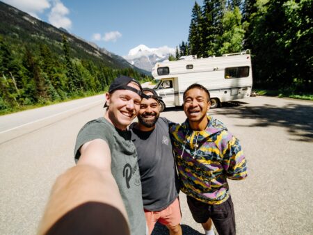 Three friends taking a selfie on their RV road trip at Mount Robson in British Columbia
