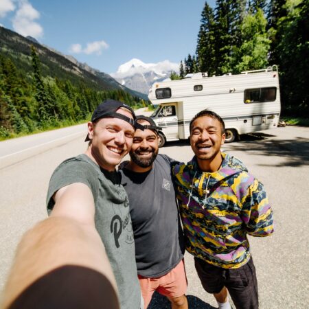 Three friends taking a selfie on their RV road trip at Mount Robson in British Columbia