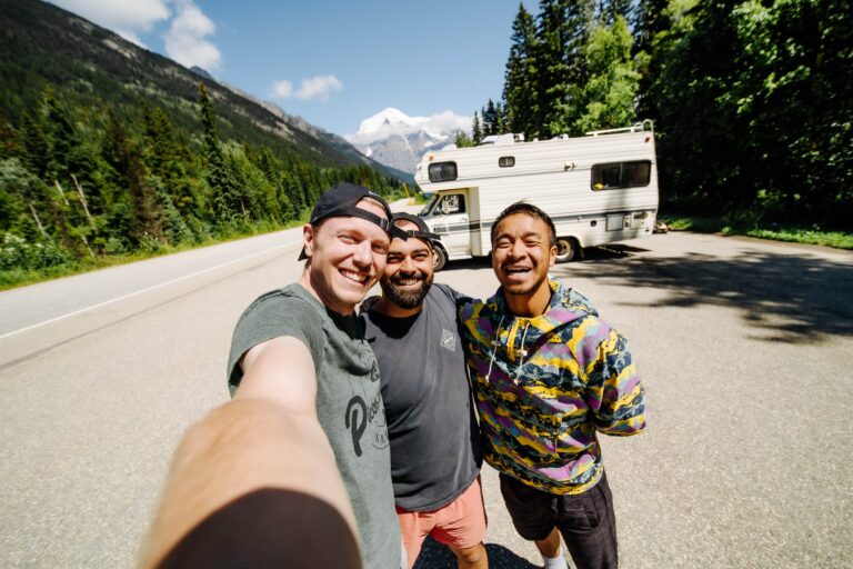Three friends taking a selfie on their RV road trip at Mount Robson in British Columbia