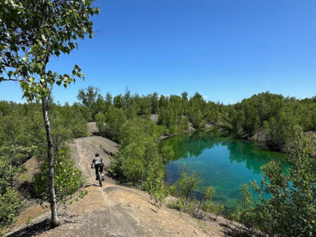 Person mountain biking in Minto New Brunswick, Minto MTB