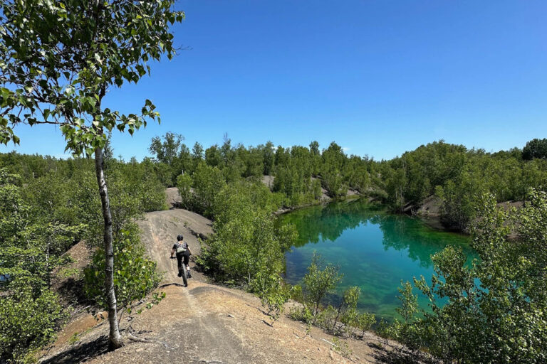 Person mountain biking in Minto New Brunswick, Minto MTB