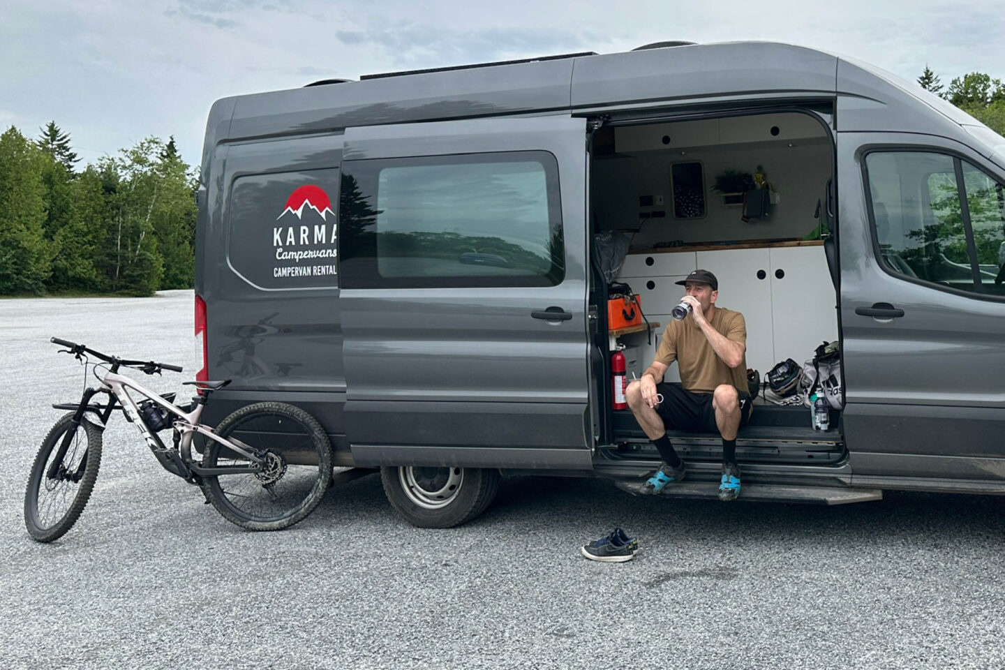 Man resting in his Class B Camper Van after a mountain biking trail ride at Rockwood Park New Brunswick