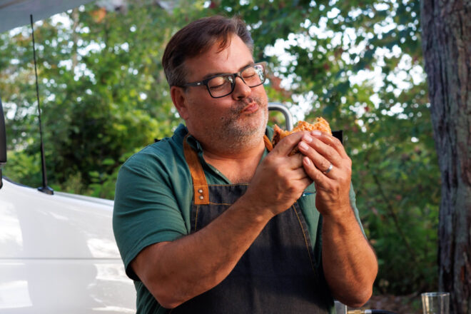 Pat Roach, Randy from the Trailer Park Boys, eating a fresh cheeseburger at his campsite