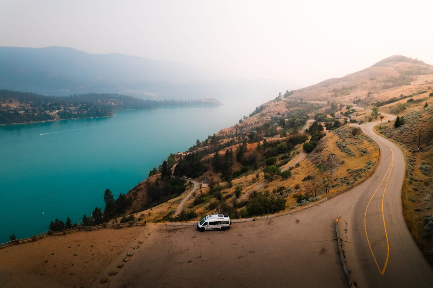 Class B camper van parked overlooking turquoise waters on Kalamalka Lake on a Vernon to Revelstoke RV road trip