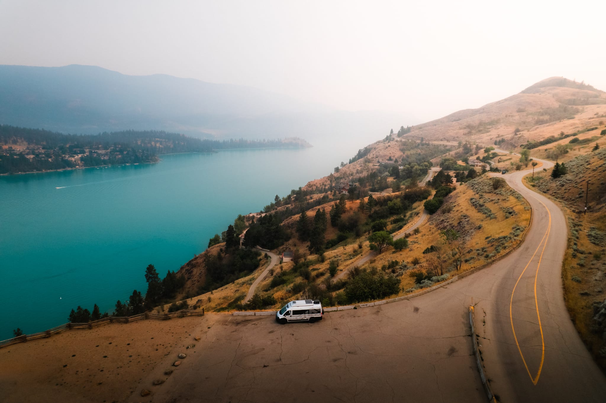 Class B camper van parked overlooking turquoise waters on Kalamalka Lake on a Vernon to Revelstoke RV road trip
