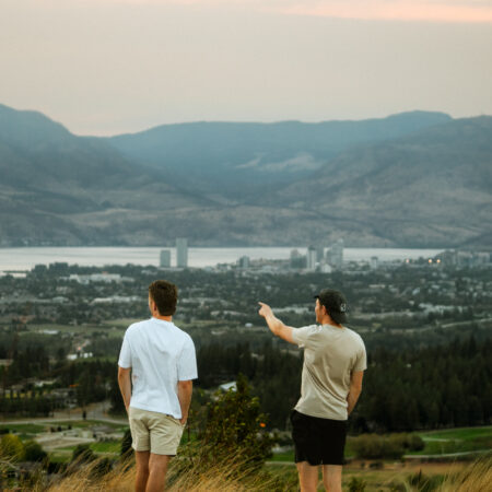 Two friends overlooking Kelowna BC on weekend RV Road Trip