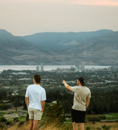 Two friends overlooking Kelowna BC on weekend RV Road Trip