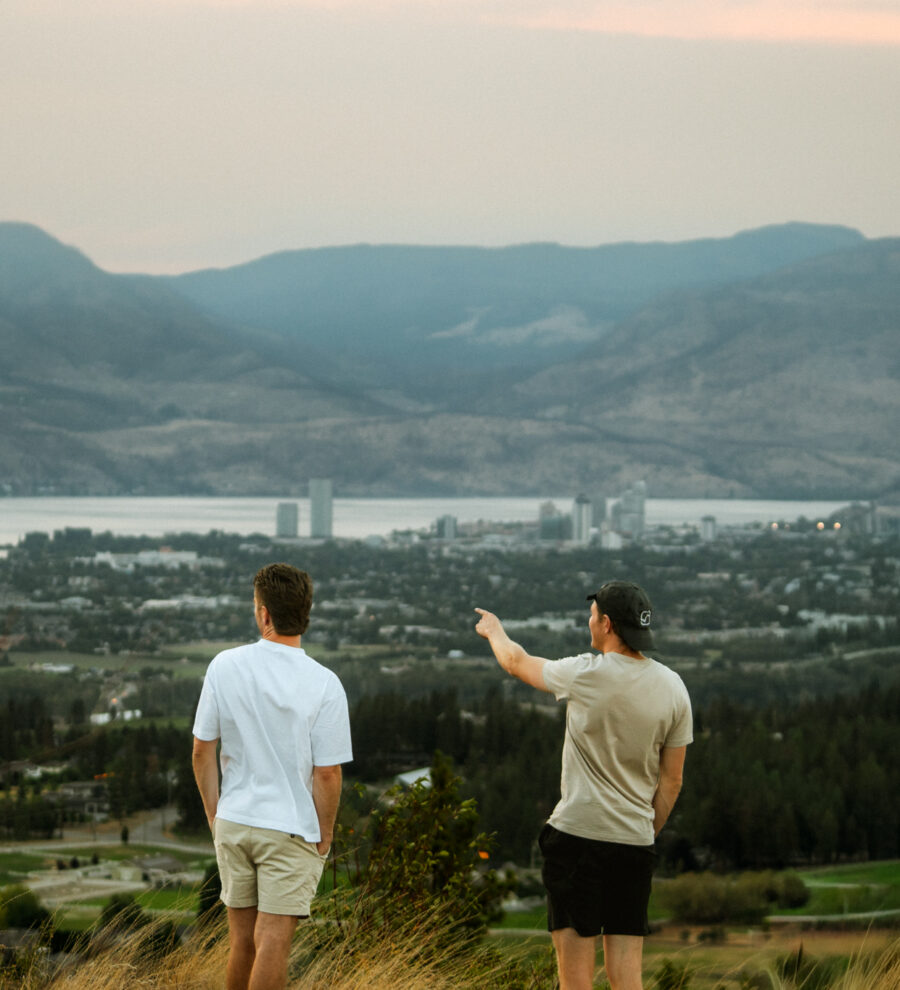 Two friends overlooking Kelowna BC on weekend RV Road Trip