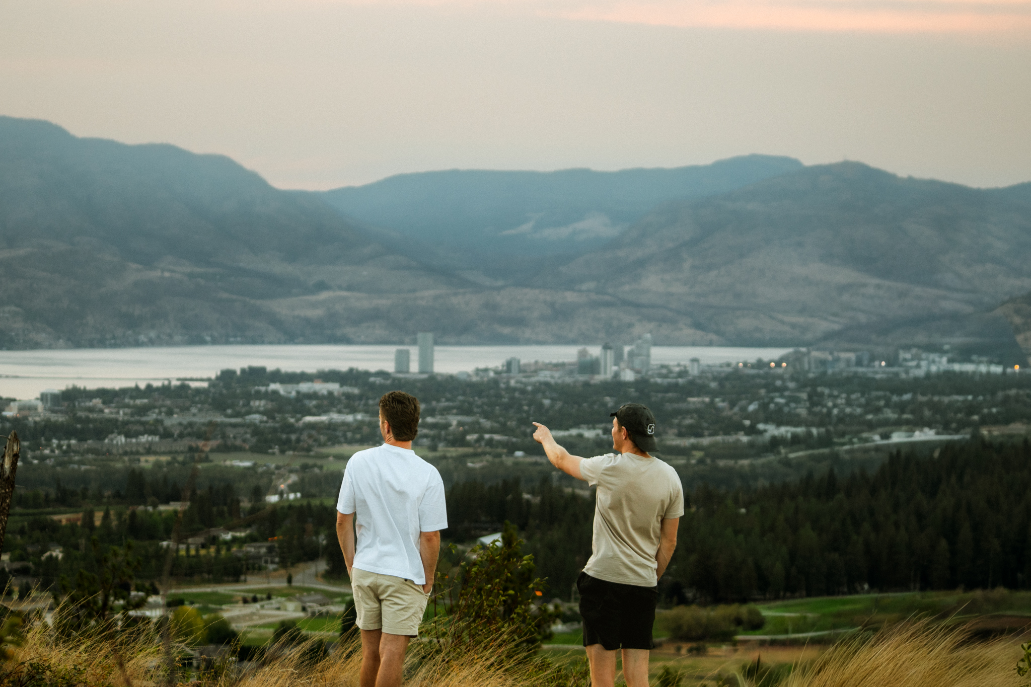 Two friends overlooking Kelowna BC on weekend RV Road Trip