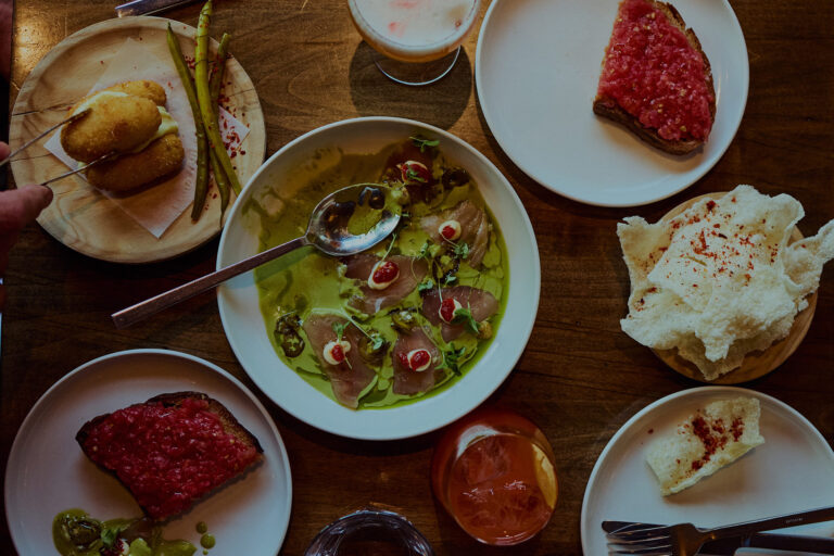 Table spread of Spanish tapas and local wine at Bocado restaurant on Picton Main Street