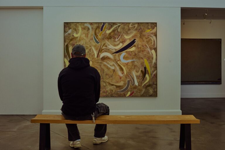 Visitor viewing contemporary Canadian paintings inside the indoor exhibition room at Oeno Gallery in Bloomfield